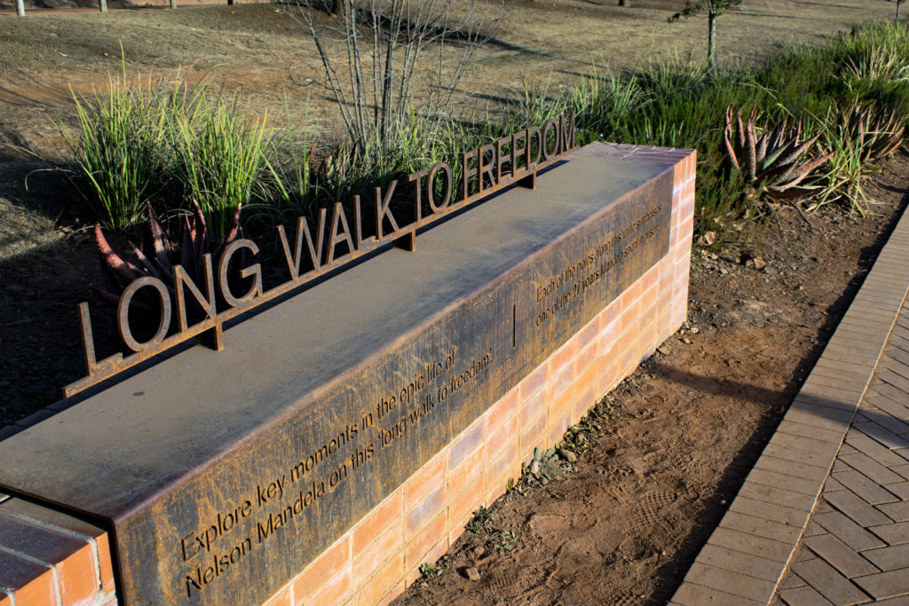 54. Howick Nelson Mandela Capture site Long Walk to Freedom: On top of a raised plinth at the side of the path, the words Long Walk to Freedom.